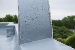 Closed cell spray foam roofing material is used at a commercial building site.